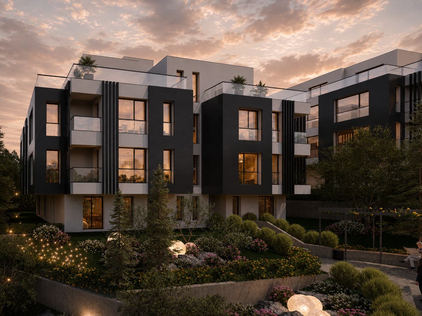 Ъглов вечерен изглед към две жилищни сгради в ALTEA RESIDENCE, обградени от зеленина